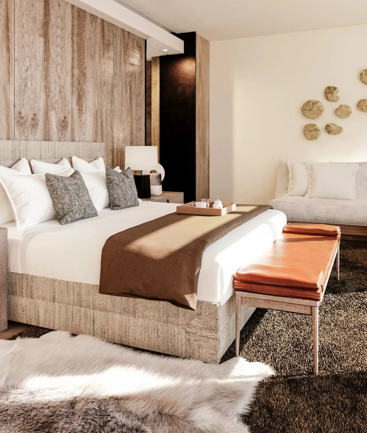 The penthouse bedroom with a wood grain panelled wall.