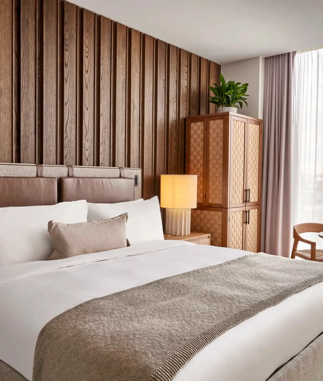 A Skyline King room with timber panelling and soft neutral bedding.