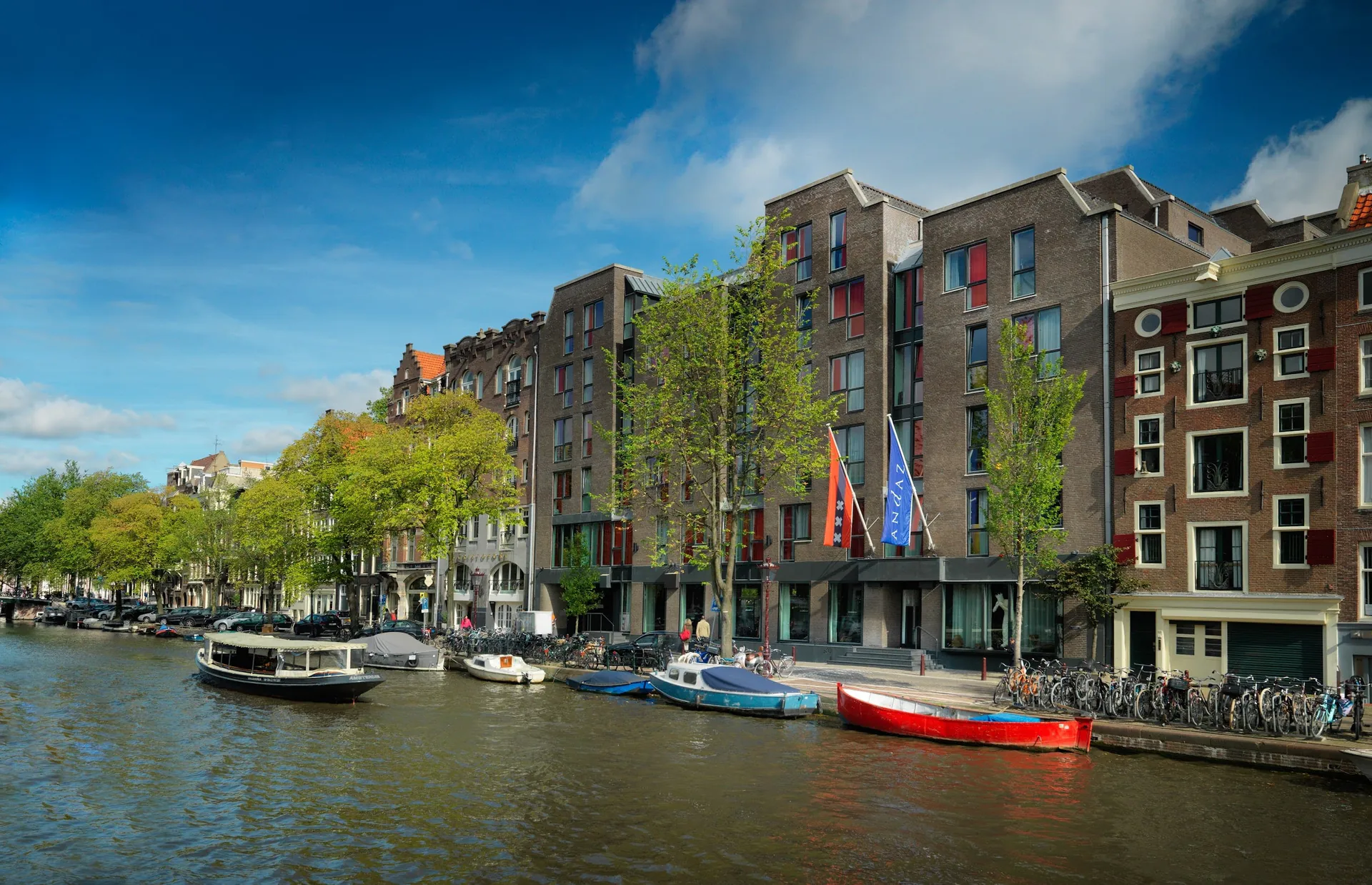 Canal houses along the Prinsengracht with boats moored in front of the hotel.