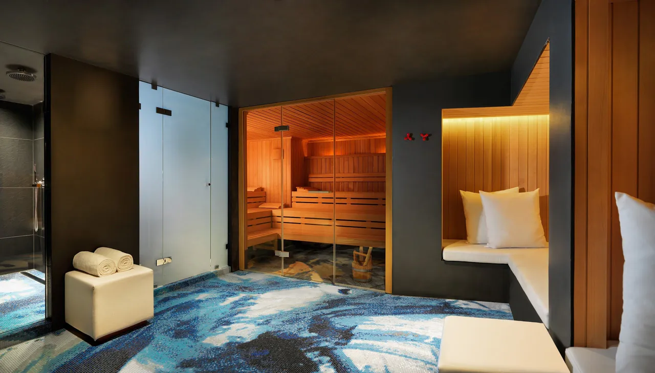A spa room with a wooden sauna and warm lighting.