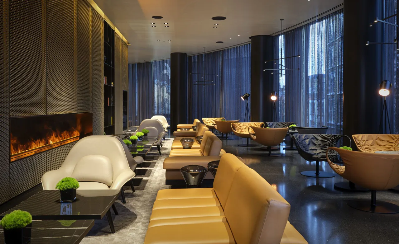 The lobby lounge with a long fireplace and soft leather seating.
