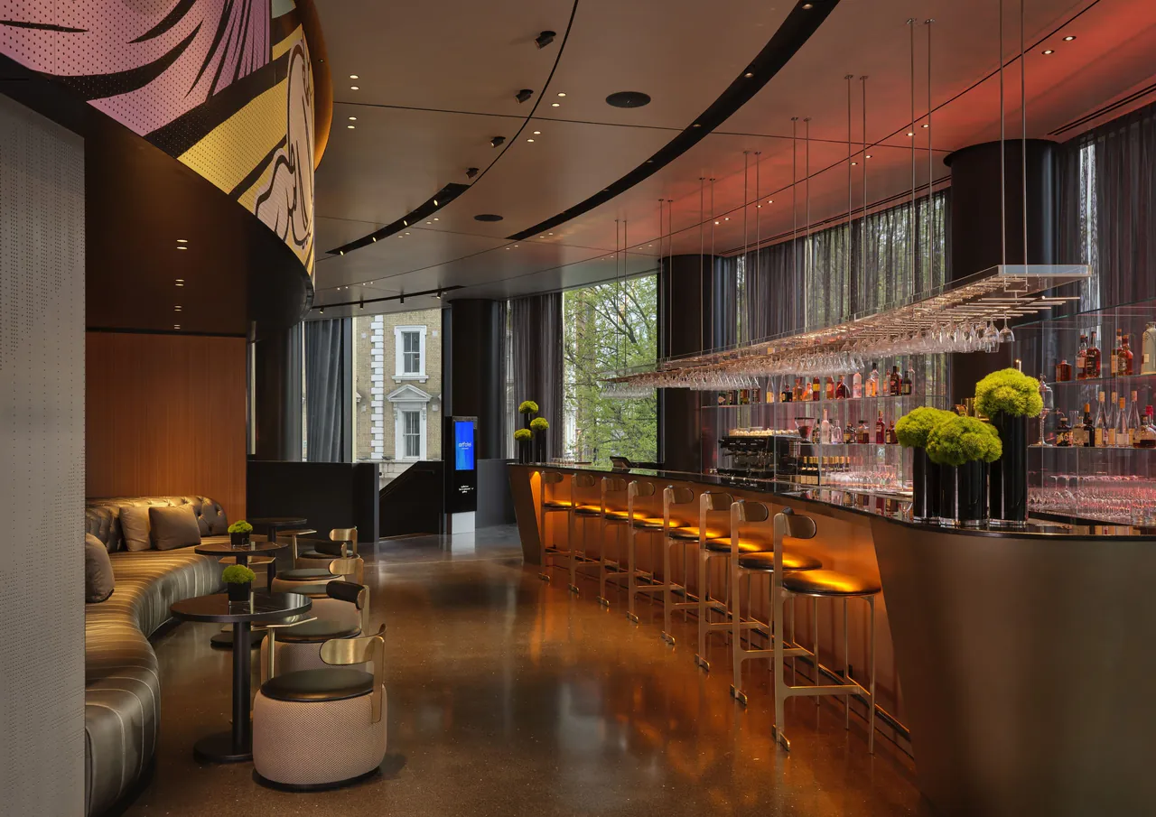 The cocktail bar with a long counter and modern seating.