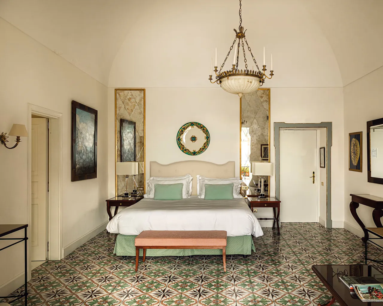 A junior suite with an apple-green bedhead and hand-painted floor tiles.