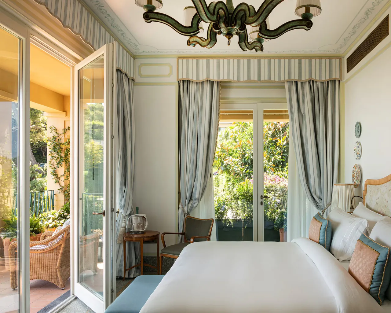 A Premium Room in pale Regency colours, with French windows open to a terrace.