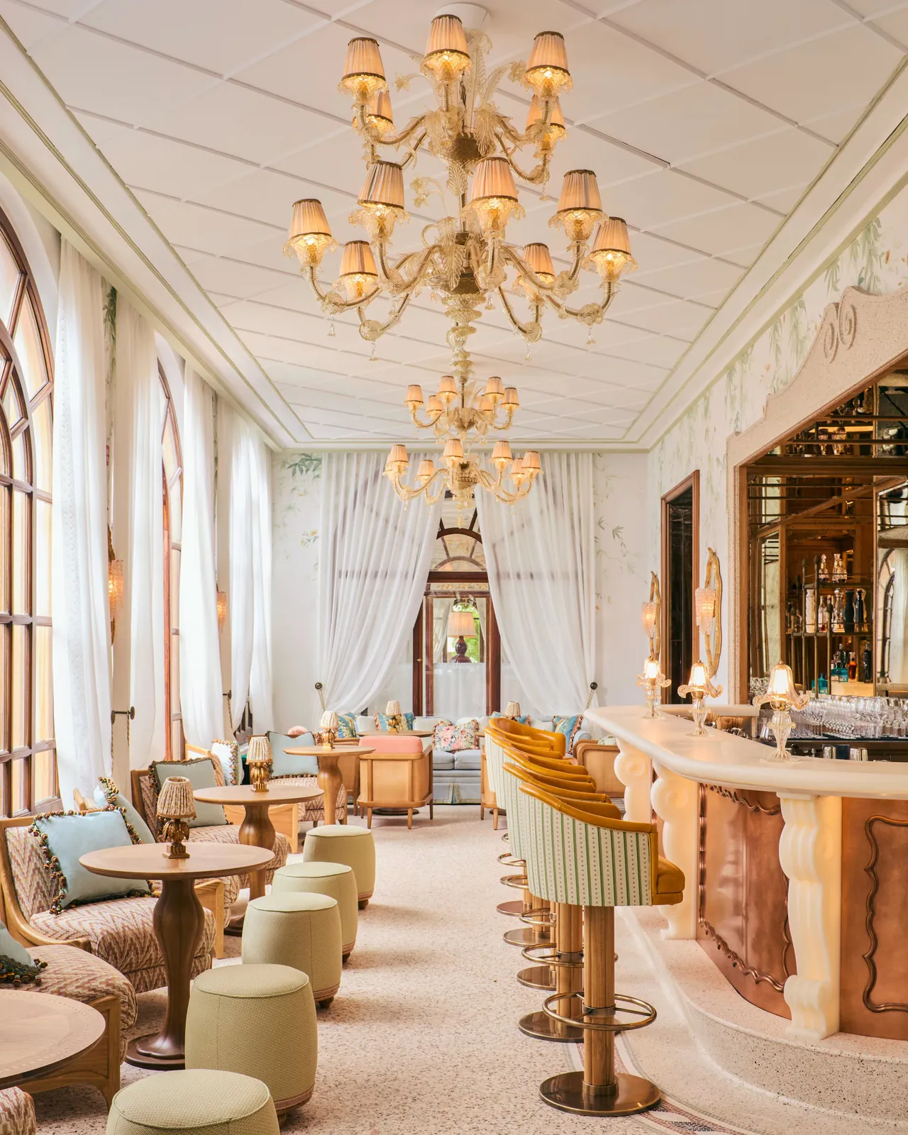 The Baratta Sedici bar, with chandeliers, tall windows and a long counter.