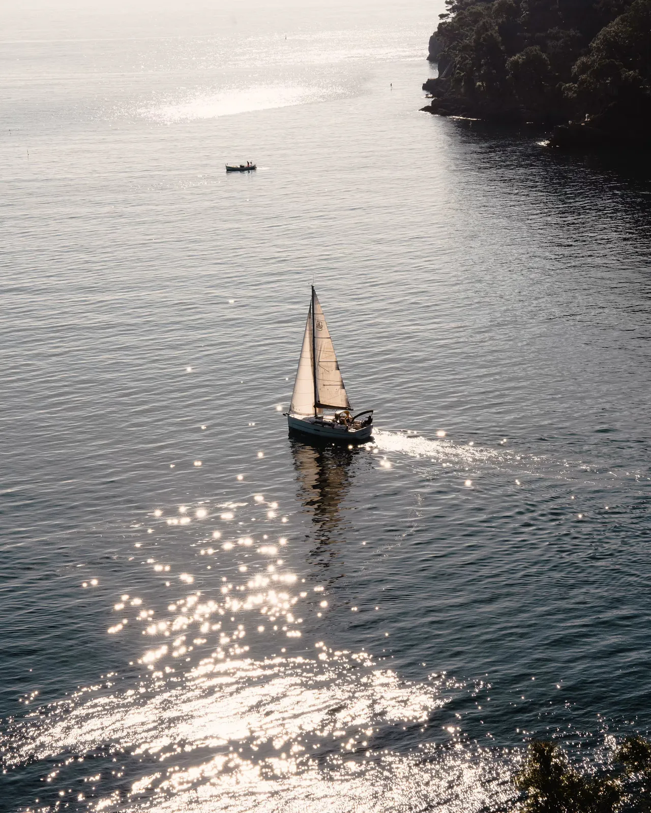 A sailing boat on the open sea off Portofino, seen from above.