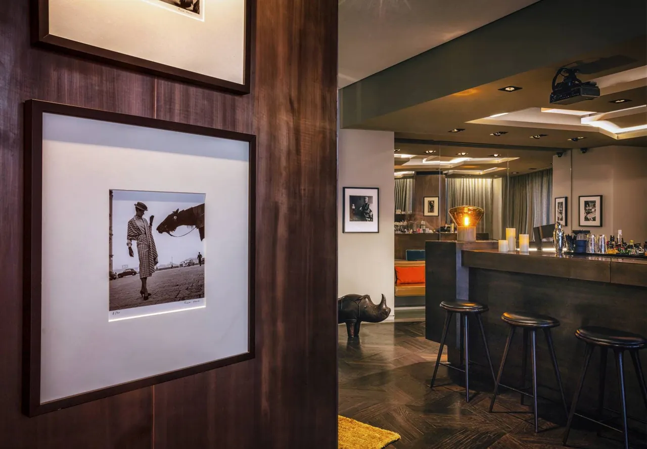 The hotel bar with framed photography and warm evening lighting.