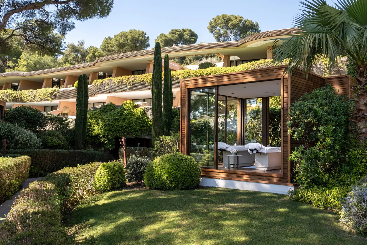 A glass-walled spa cabana in the gardens below the hotel wing.