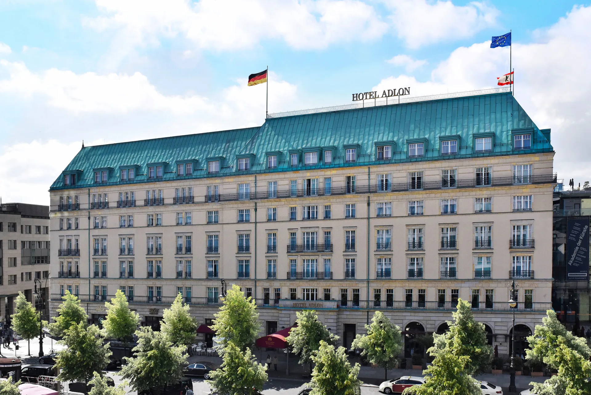 The pale facade and green copper roof of Hotel Adlon on Unter den Linden.