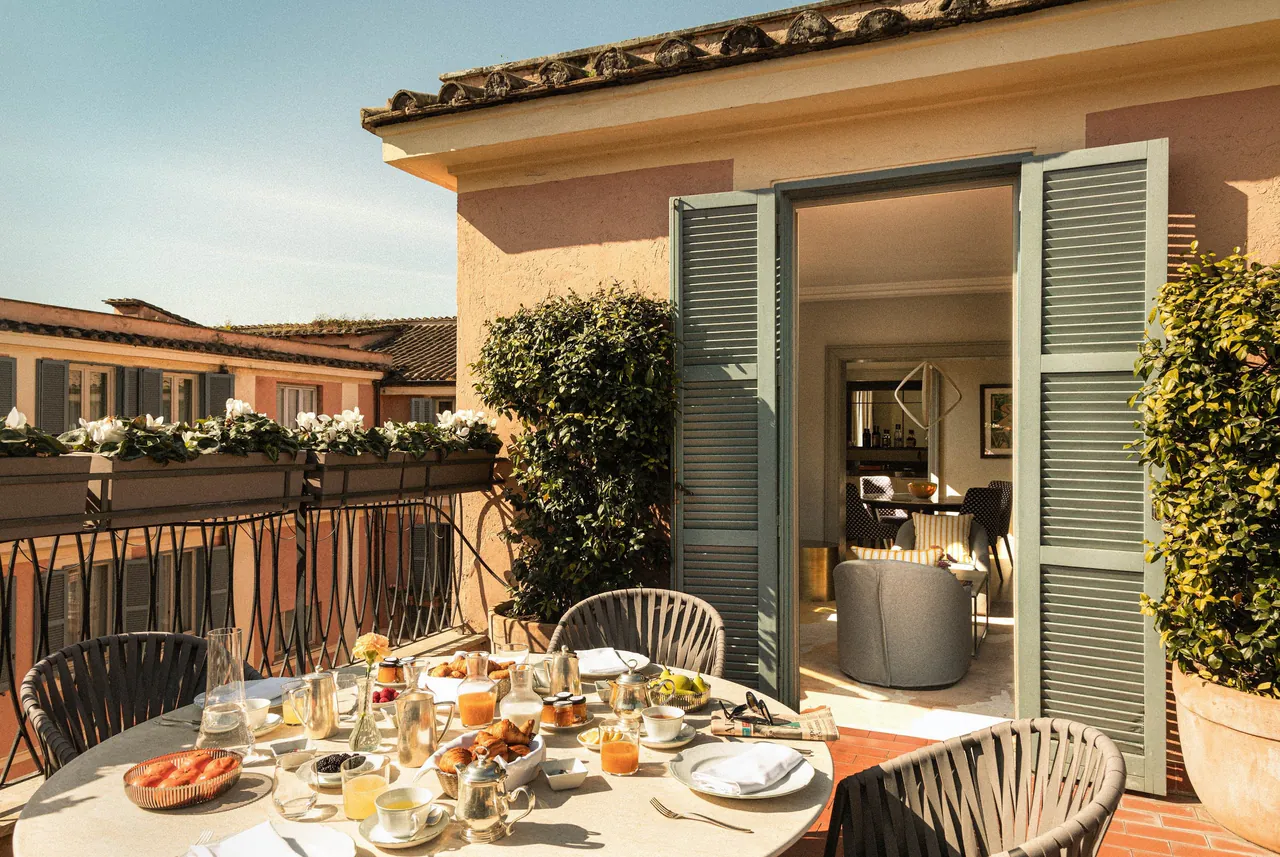 Breakfast laid out on a sunny suite terrace above the Roman rooftops.
