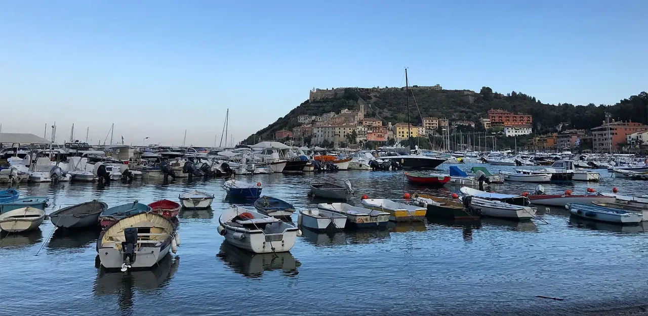 Boats moored in the harbour of Porto Ercole below the old fortress.