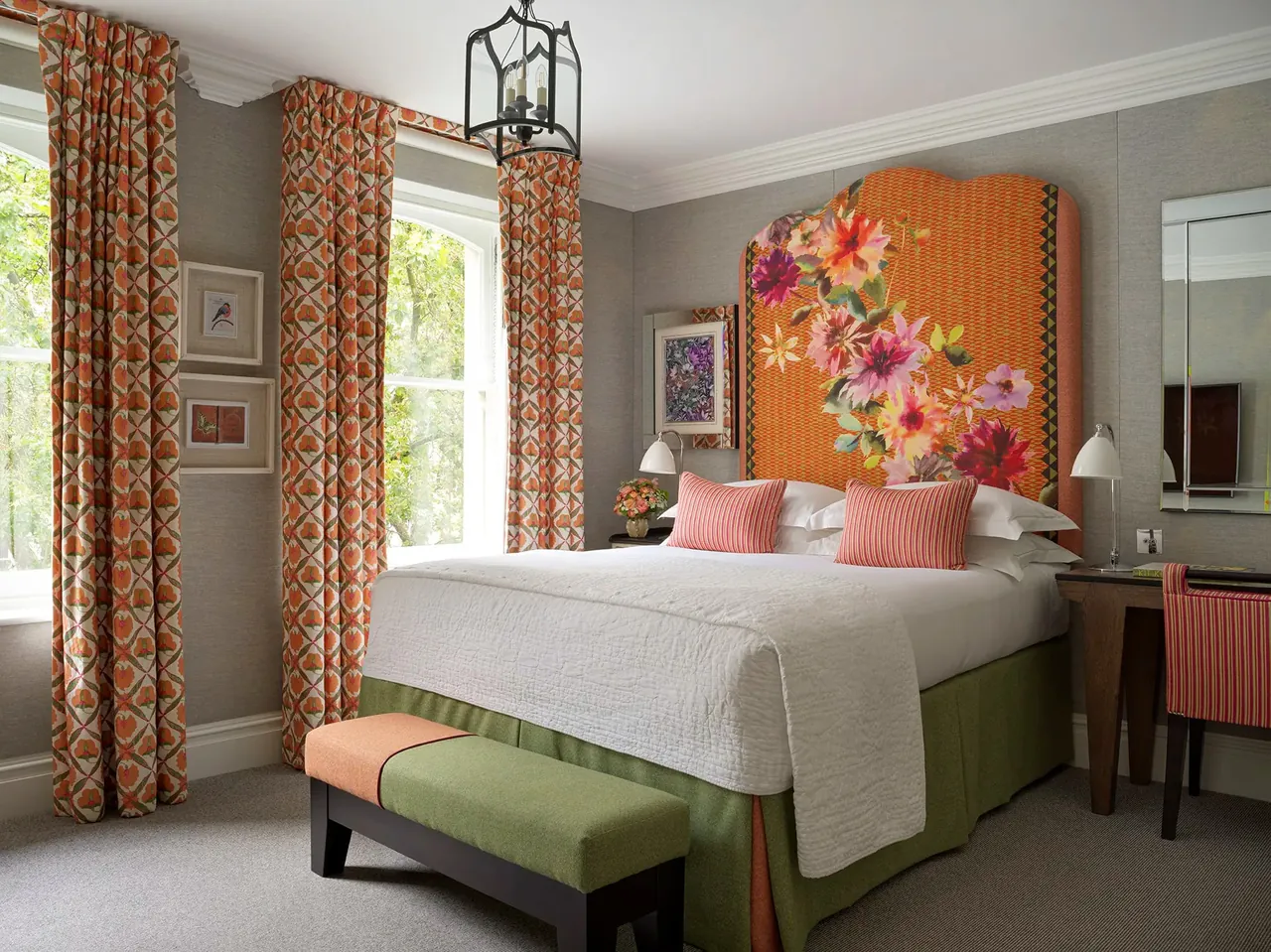 Luxury Room with an orange floral headboard and striped curtains.