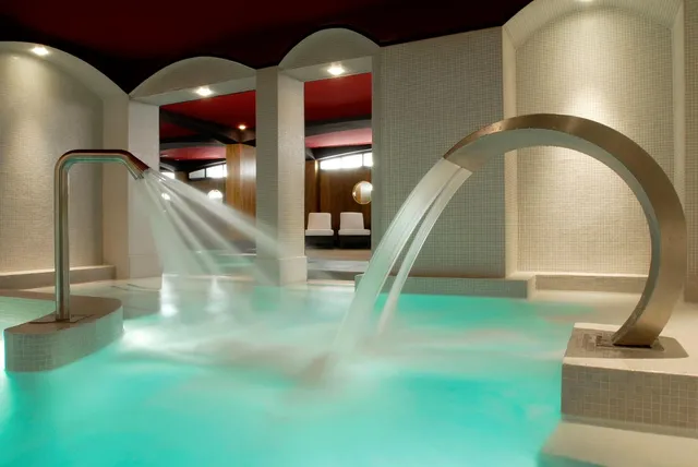 Spa pool at Le Fouquet's Barriere, Paris, with curved steel water jets and mosaic-tiled walls