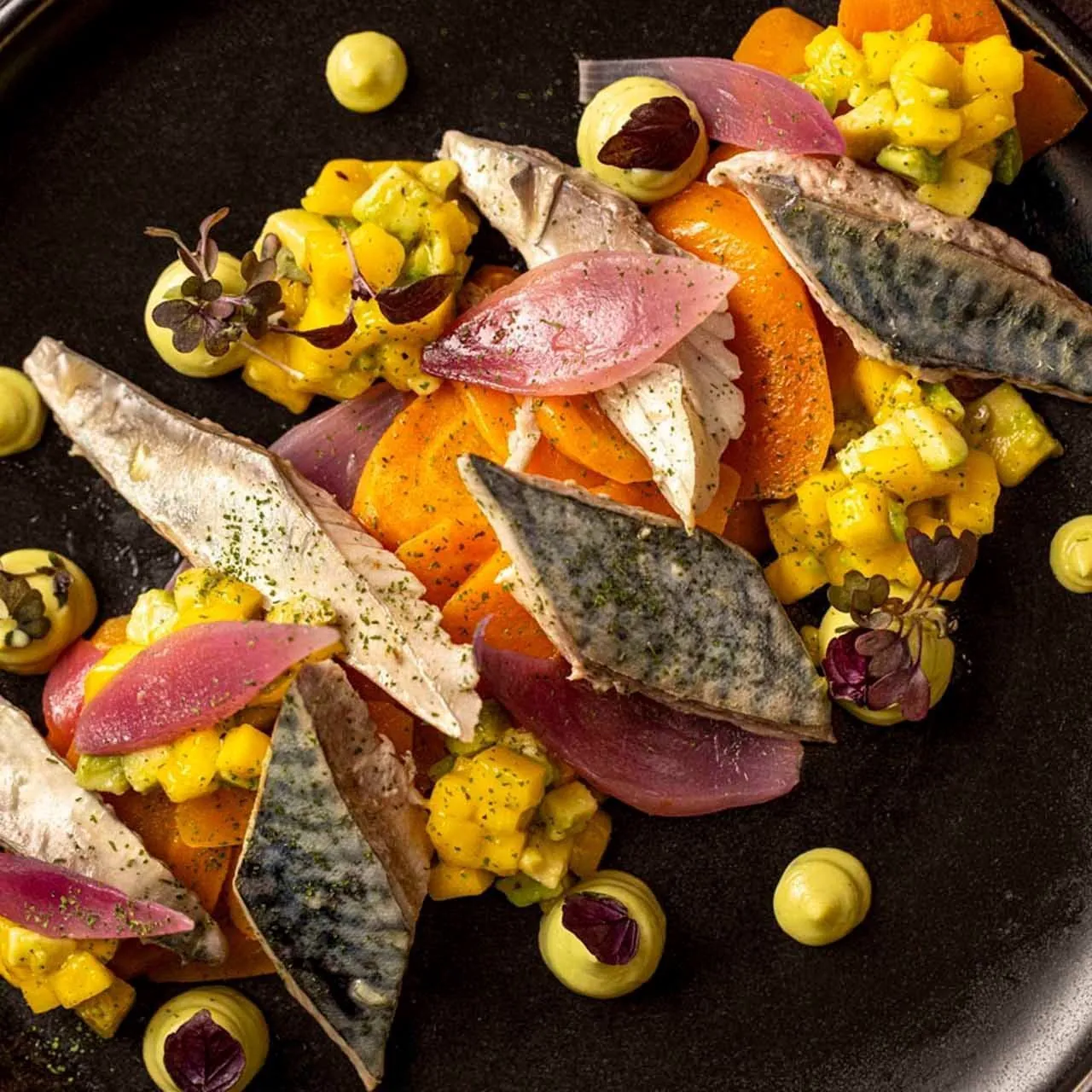 A colourful plate of fish, vegetables and olives served at EMME.