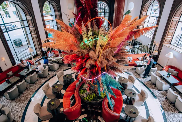 A view from above of the lobby bar and its large orange flower arrangement.
