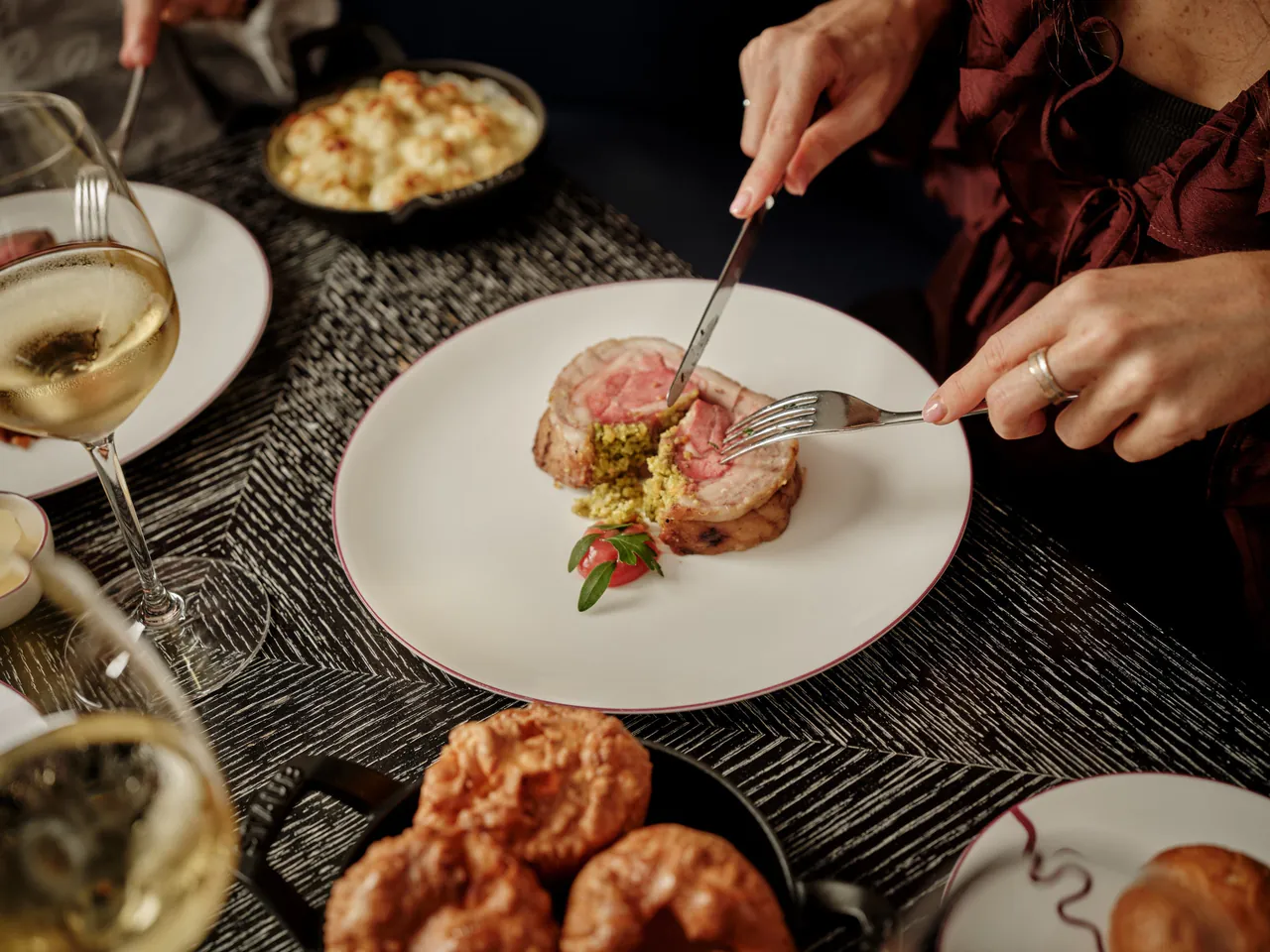 A Sunday roast being served at a dark table in the restaurant.
