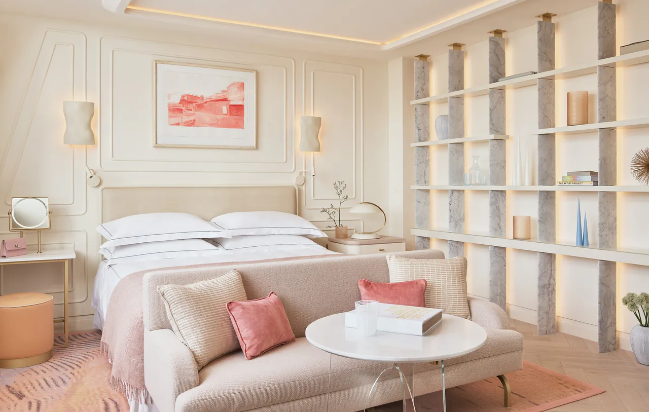 A light bedroom with shelves, a sofa and a small round table.