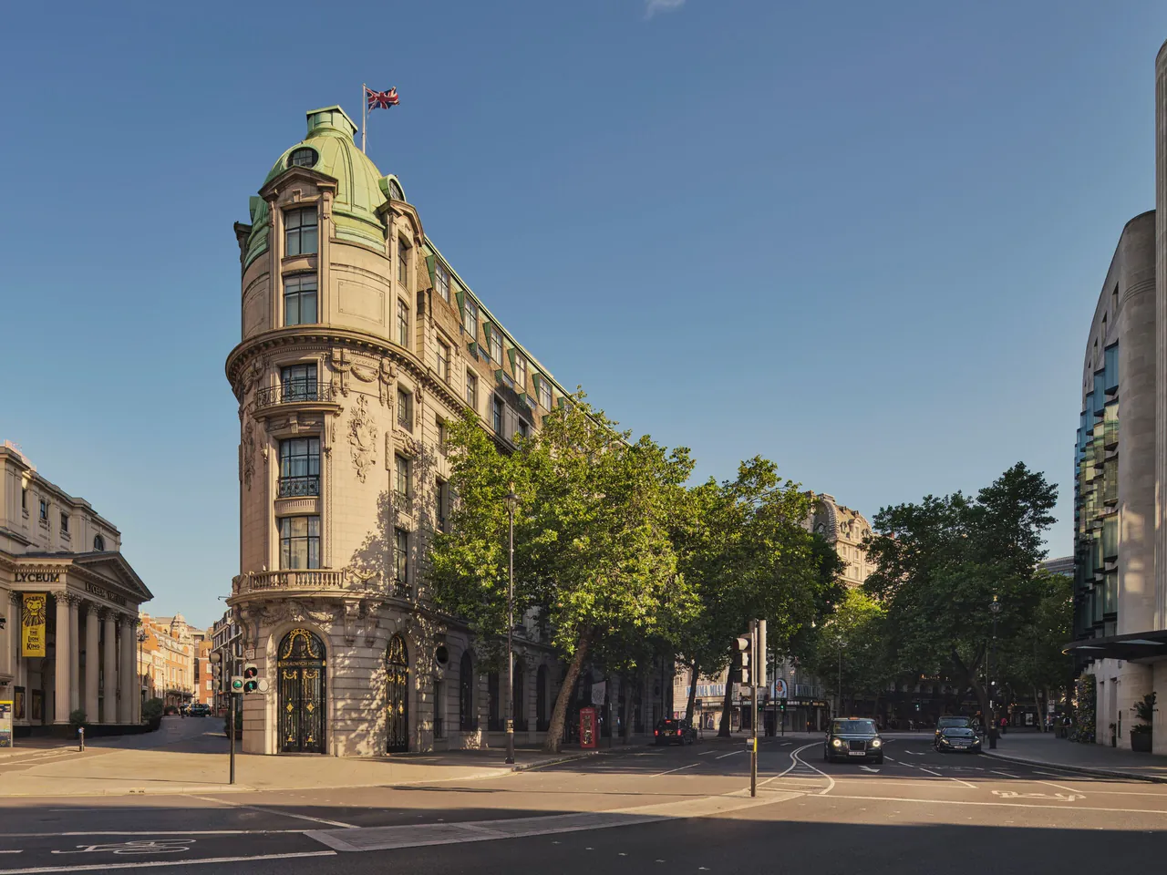The rounded corner facade of One Aldwych on a sunny day.