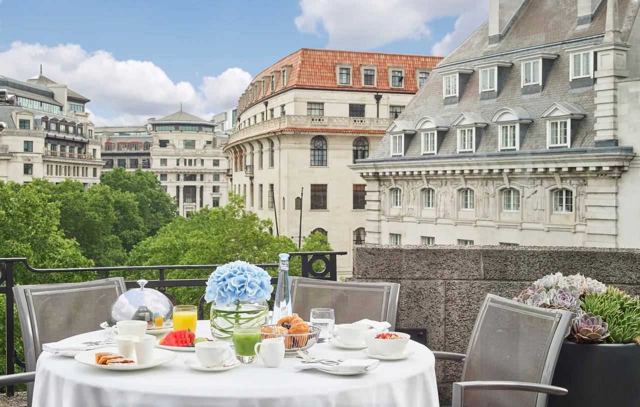 A breakfast table on a terrace overlooking the buildings of Aldwych.