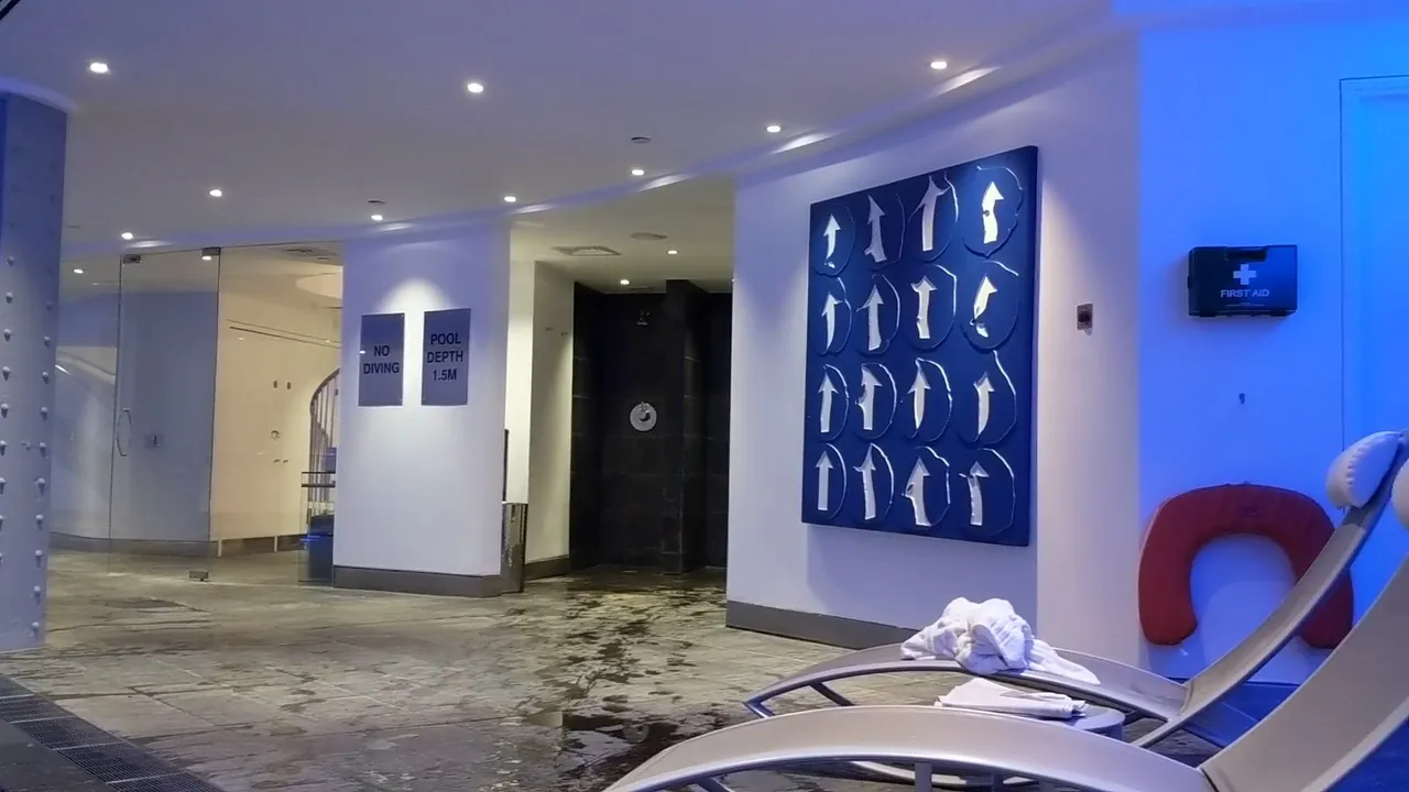 The spa corridor with loungers and blue artwork on the wall.