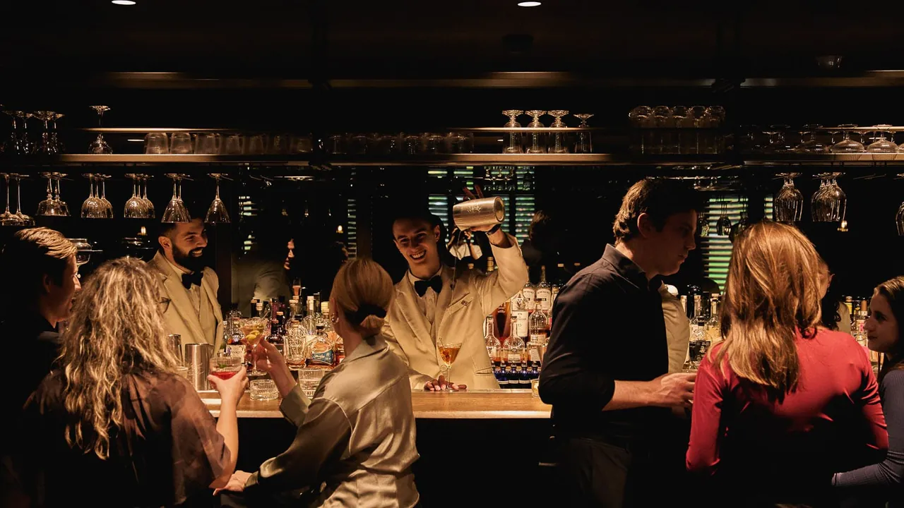 Bartenders mixing cocktails for guests at Fitz's bar.