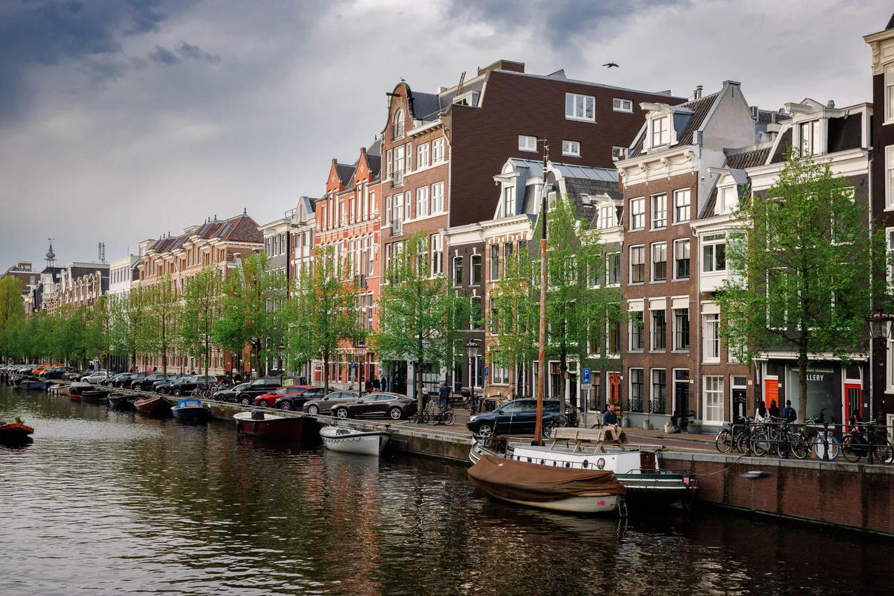 Canal houses and moored boats along an Amsterdam canal.