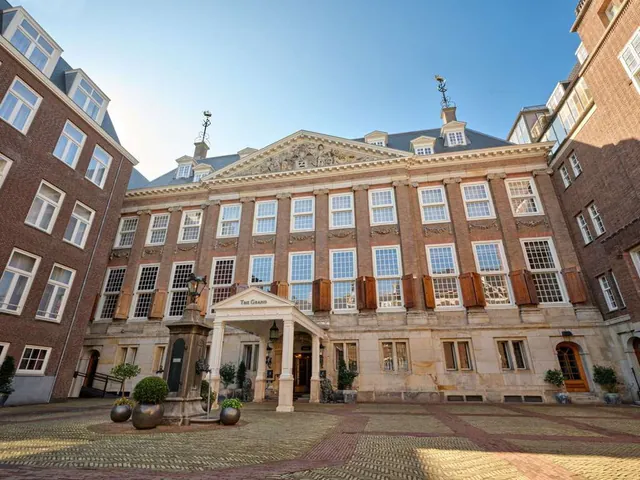 The classical brick facade of the hotel seen from its cobbled forecourt.