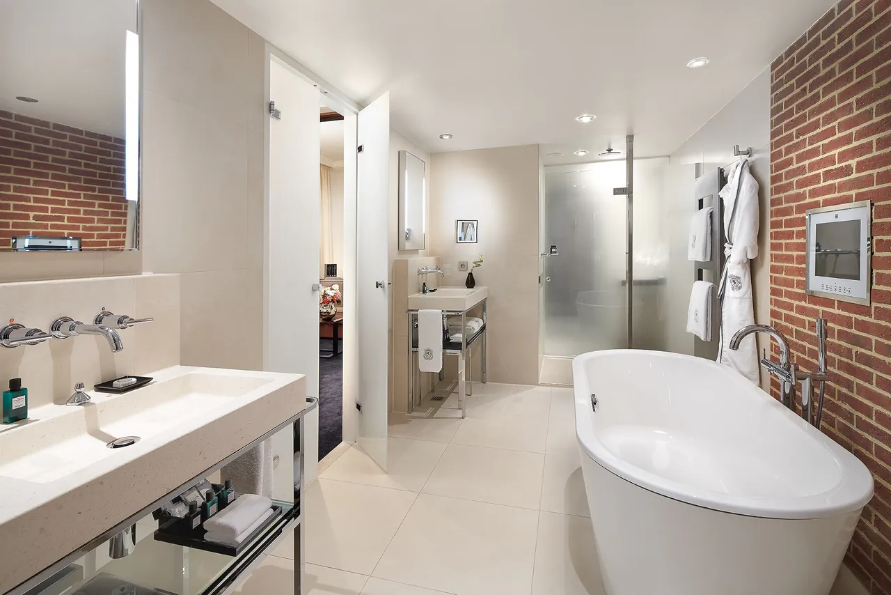 A white bathroom with a freestanding tub and a walk-in shower.