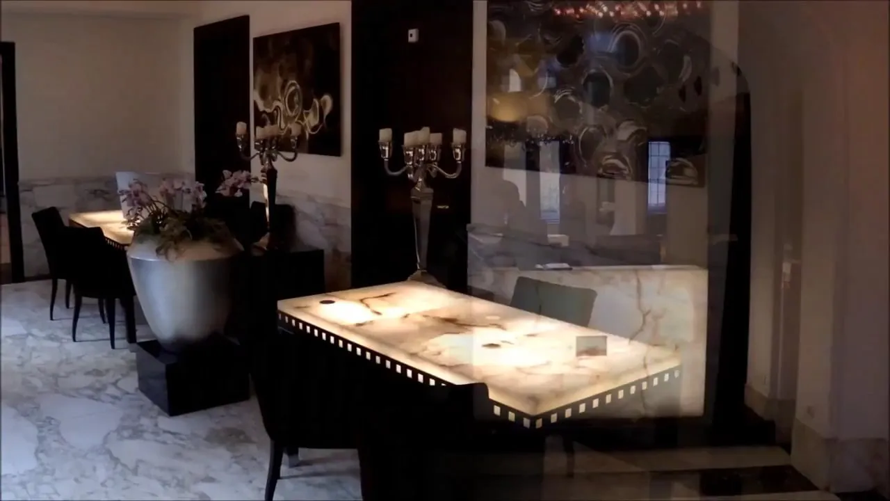 A dark, intimate dining room with a softly lit table.