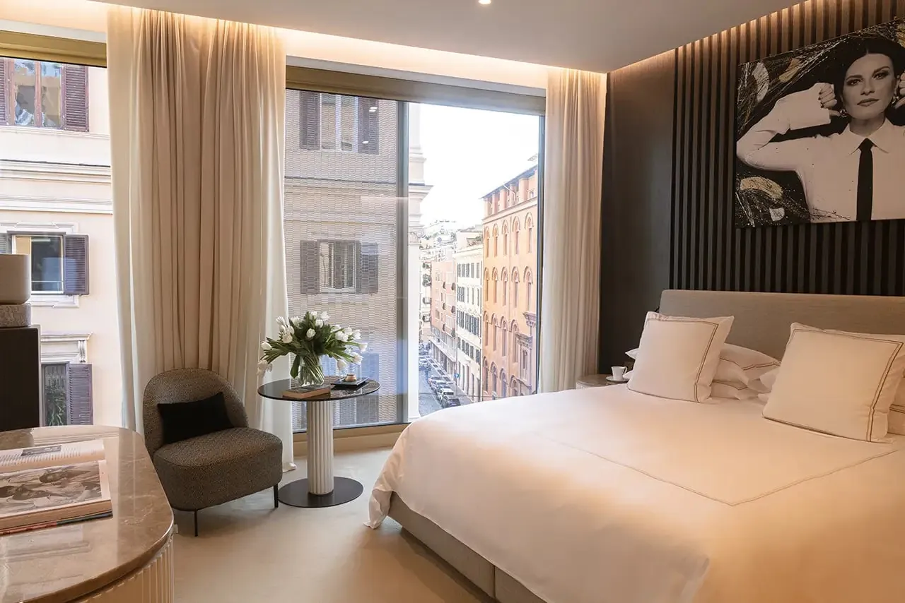 Prestige room with a singer's portrait above the bed and a street view.