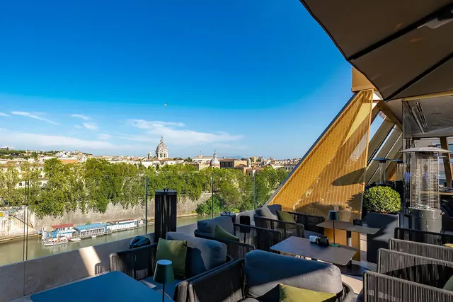 Covered rooftop dining terrace overlooking the river and the city.