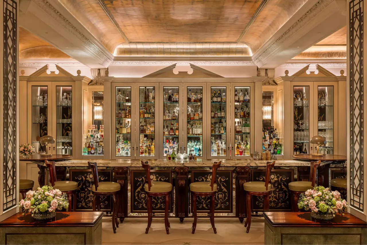The cocktail bar with its gilded ceiling and glass-fronted cabinets.