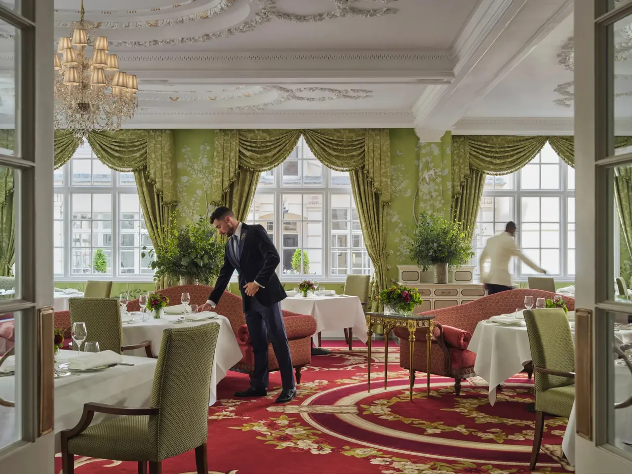 The Dining Room with green silk walls and garden-facing windows.