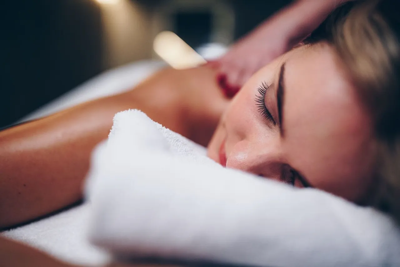 A guest relaxing during a back massage in the hotel spa.