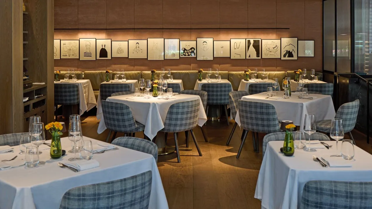 Whitcomb's restaurant with white tablecloths and blue checked chairs.