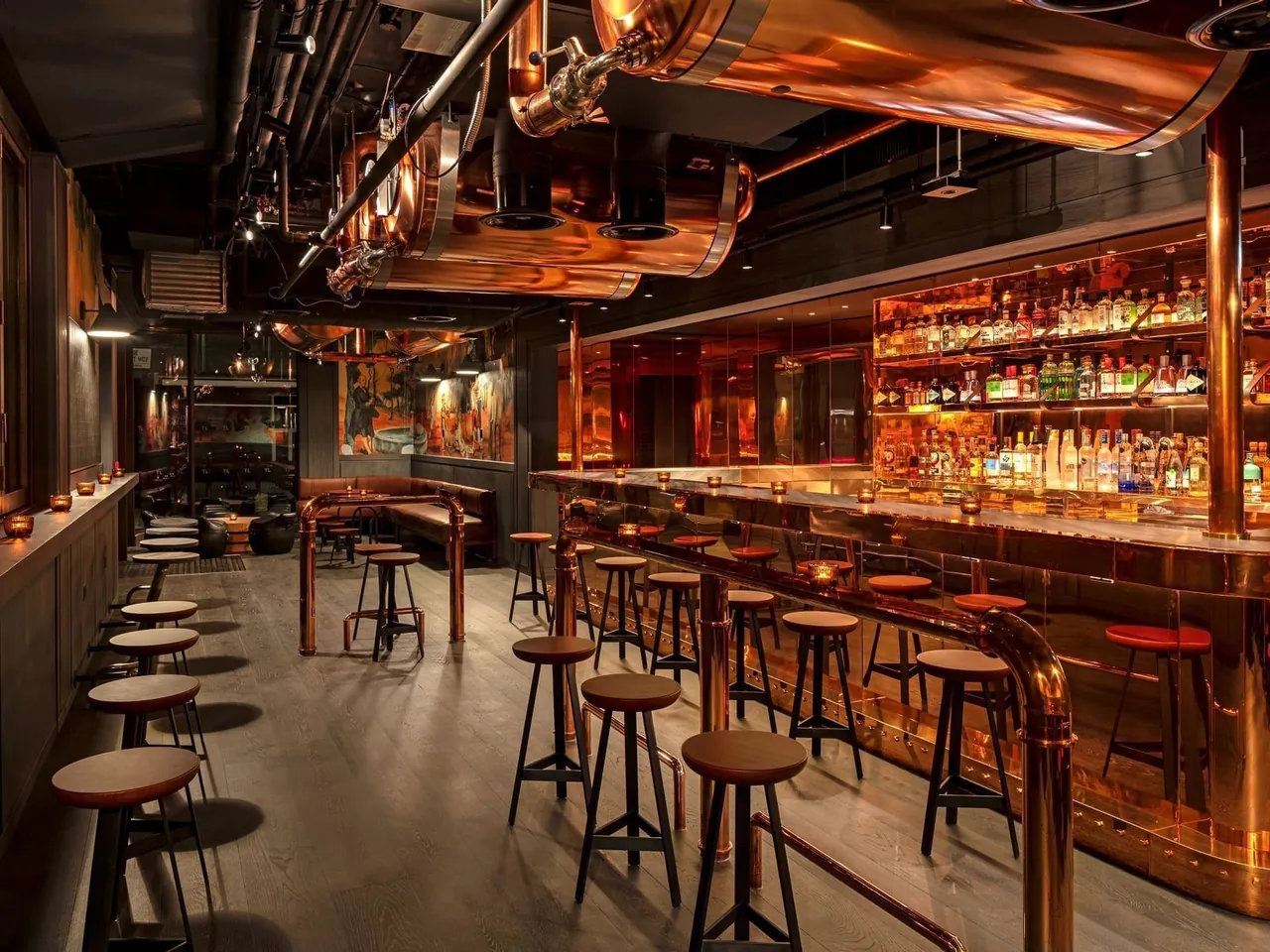 Joshua's Tavern with copper pipework above a warmly lit bar.