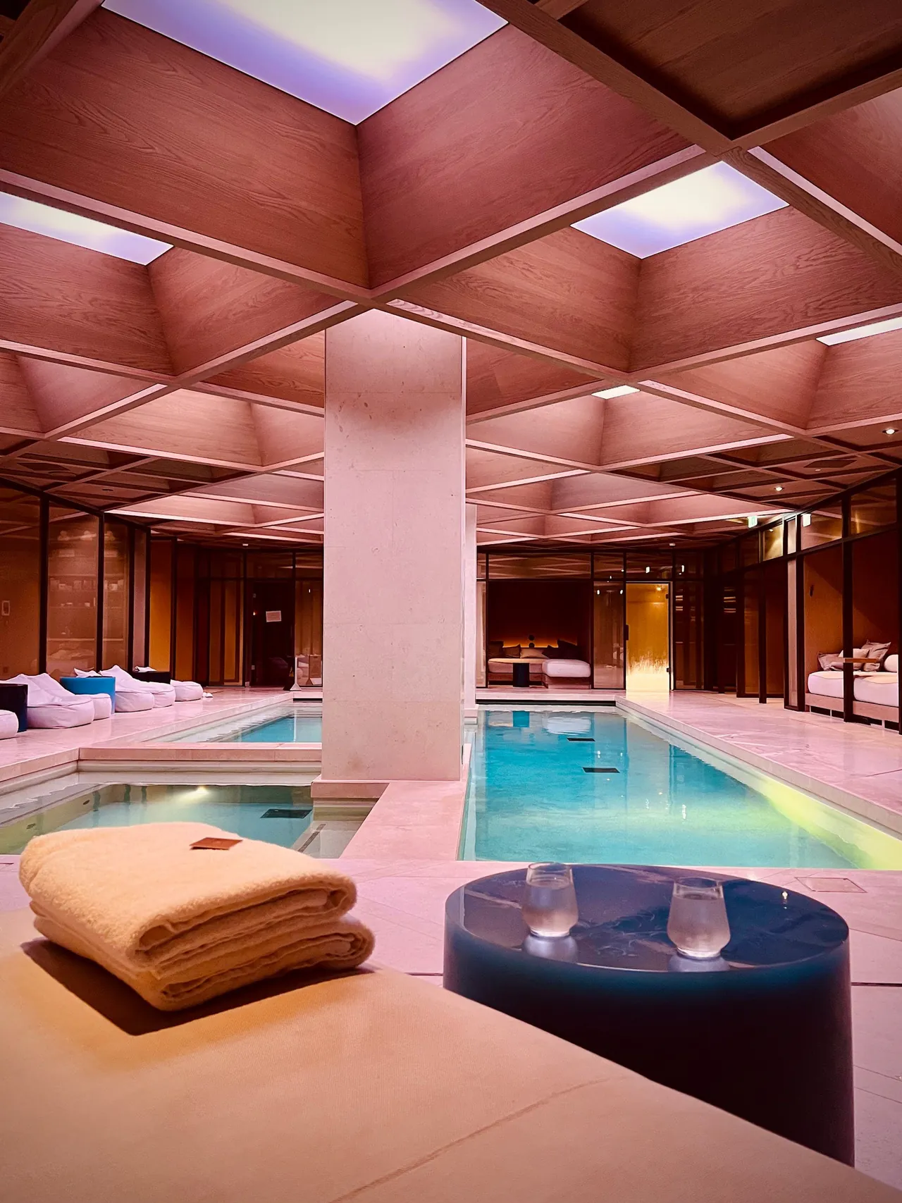 The indoor pool under a wooden coffered ceiling with skylights.
