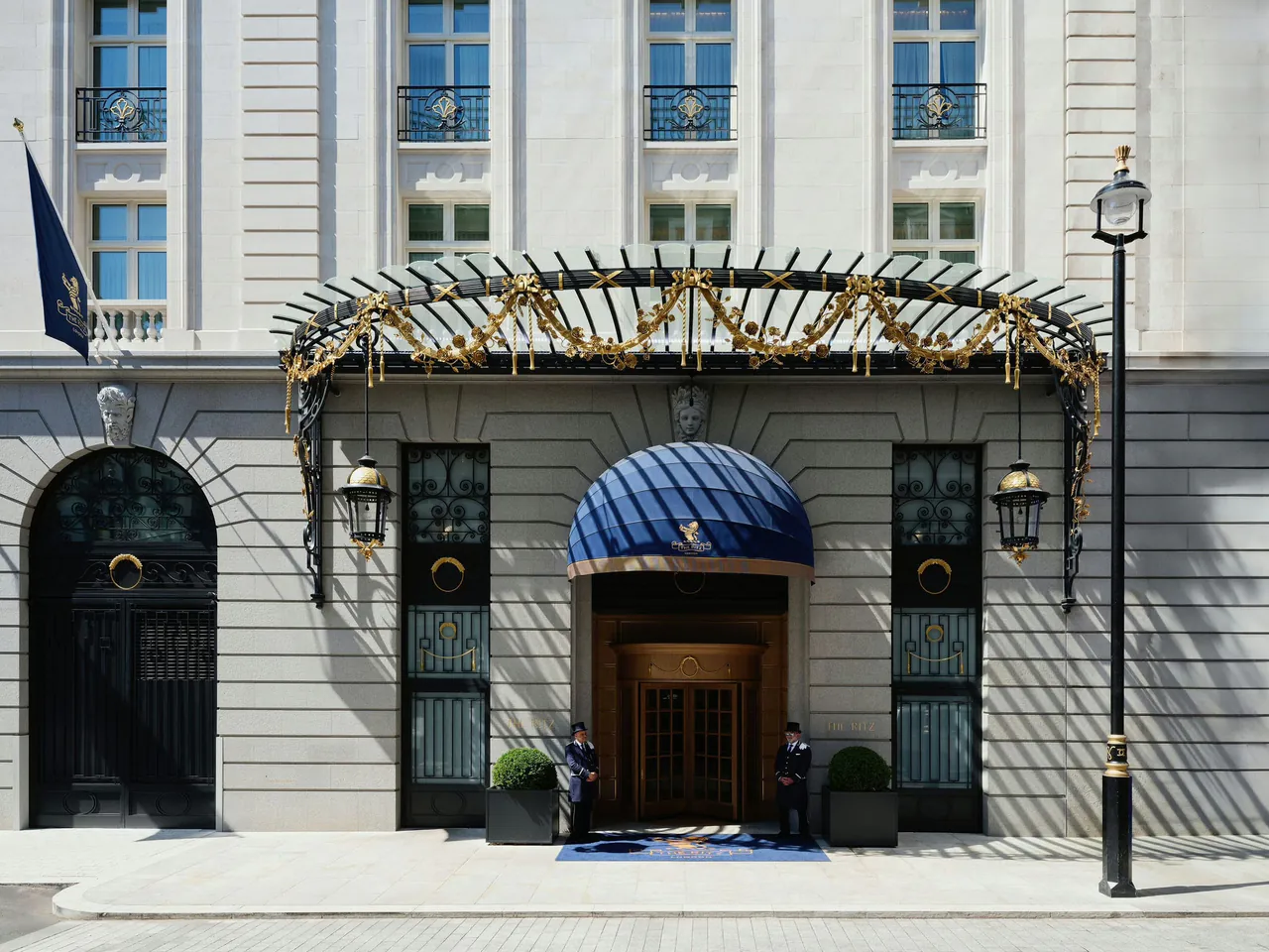 The arcaded entrance of The Ritz London on Piccadilly with its blue canopy.