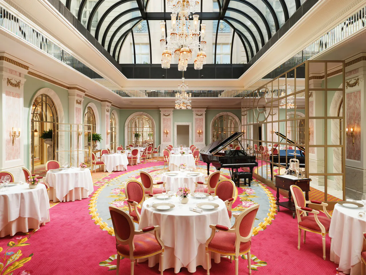 The Ritz Restaurant set for lunch beneath a glass ceiling.