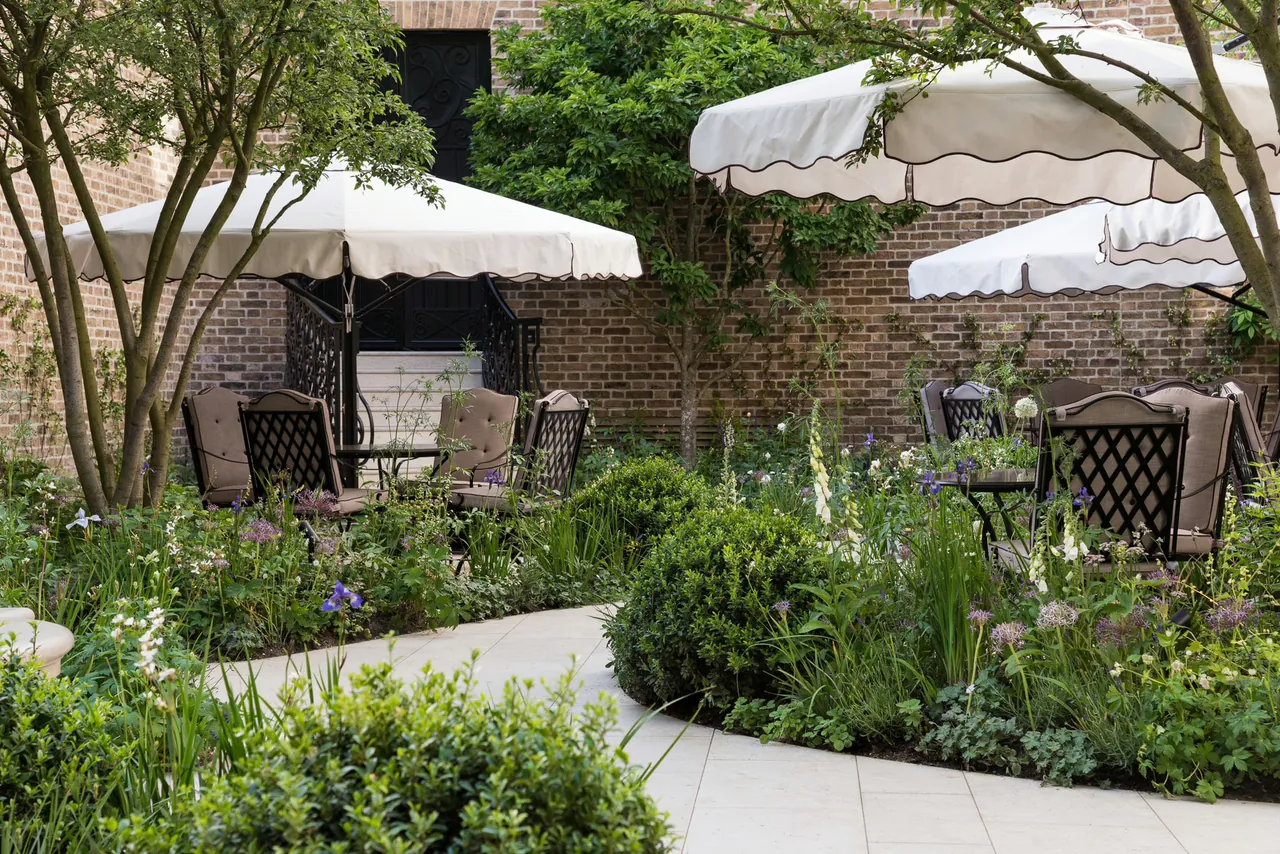 Parasols and lush planting in The Secret Garden terrace.