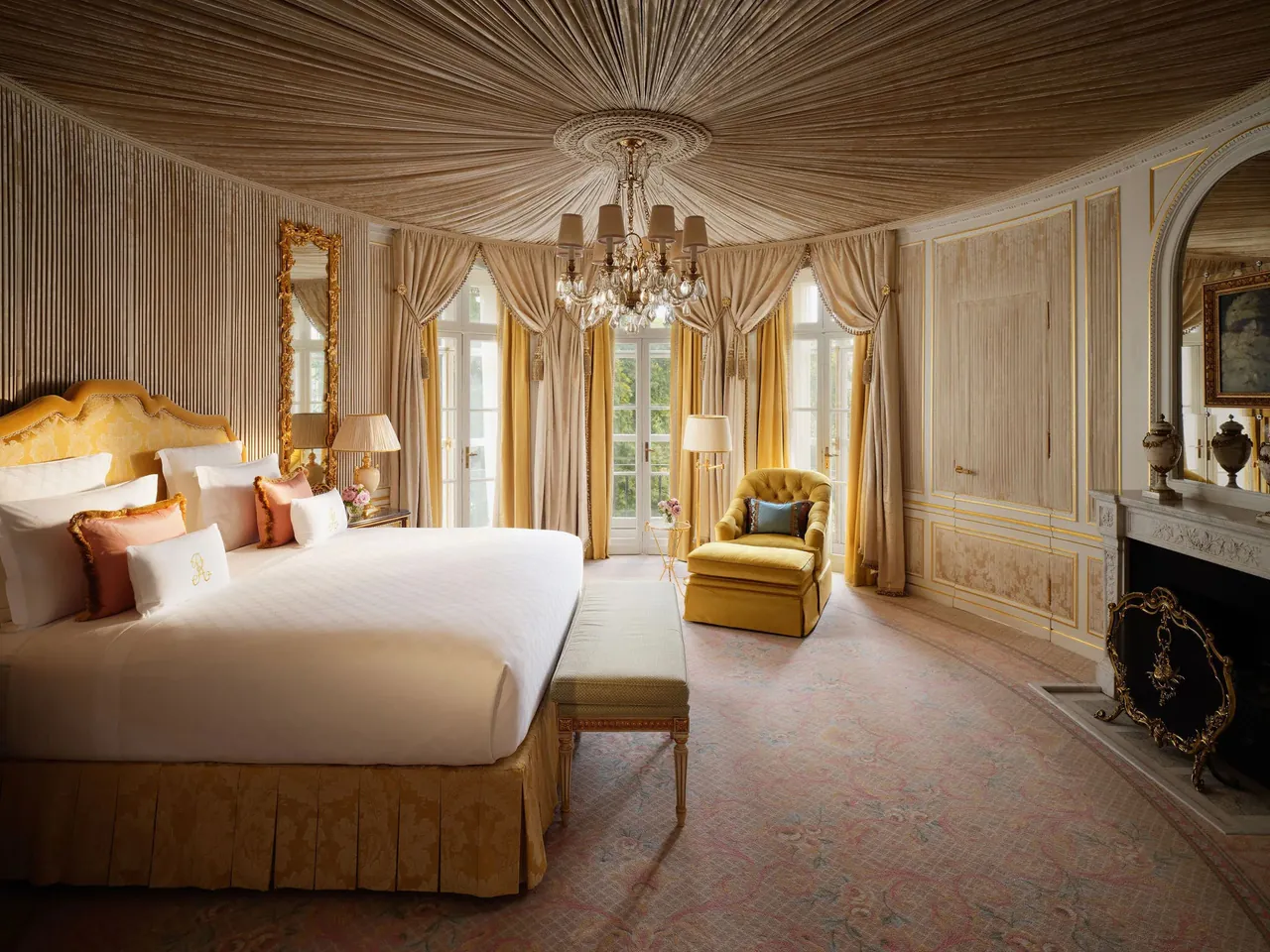 The Royal Suite bedroom with a draped ceiling and a fireplace.