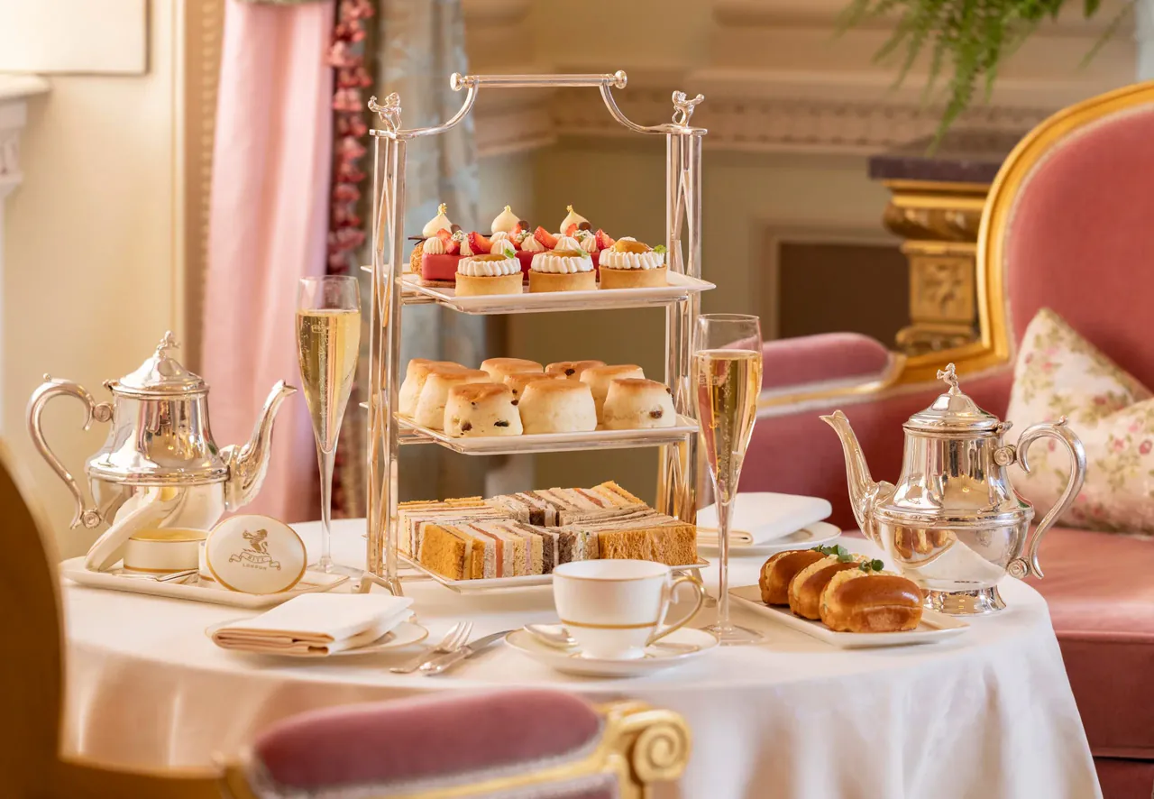 A tiered stand of sandwiches, scones and pastries for afternoon tea.
