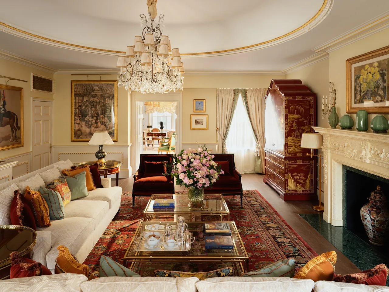 The Prince of Wales Suite lounge with antiques and a marble fireplace.