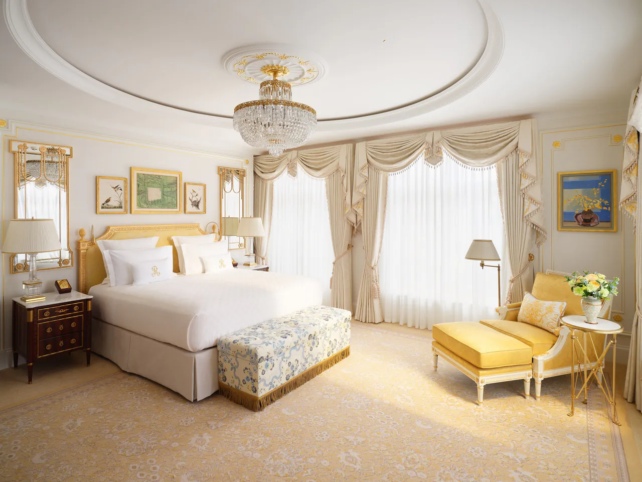 A Grand Deluxe Room in soft yellow with a gilded ceiling rose.